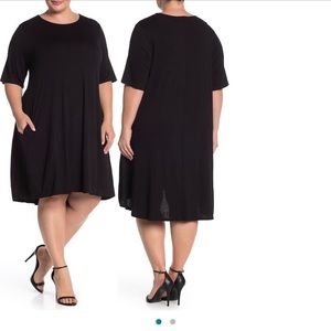 Black jersey knit Philosophy dress, mid calf length. Has two side seam pockets.